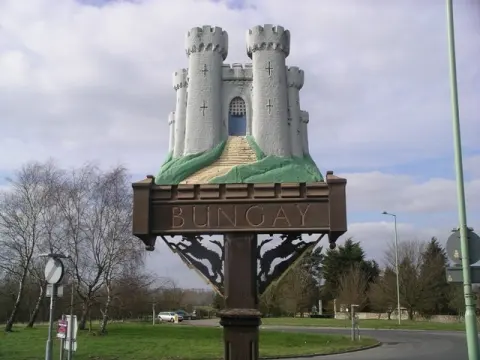 Scrap Cars In Bungay Village Sign